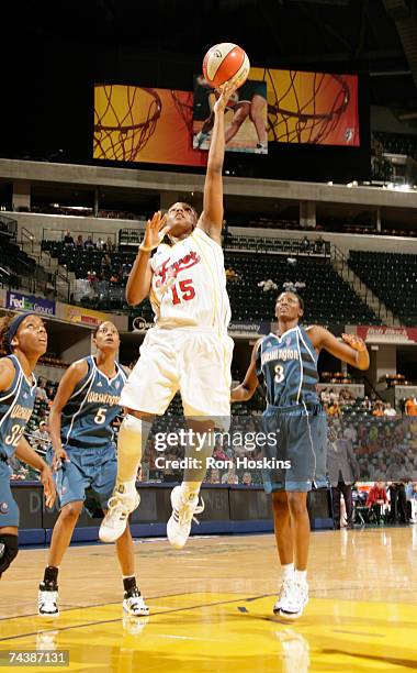 Tan White of the Indiana Fever scores on Stacey Lovelace-Tolbert and DeLisha Milton-Jones at Conseco Fieldhouse June 3, 2007 in Indianapolis,...