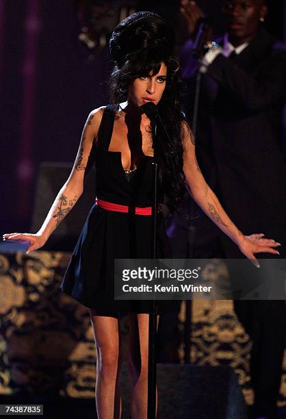 Singer Amy Winehouse performs "Rehab" onstage during the 2007 MTV Movie Awards held at the Gibson Amphitheatre on June 3, 2007 in Universal City,...