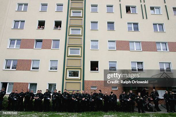 Riot police guard the so-called "sunflower house" during a protest against the migration policies of the G8 states and racism in general on June 4,...