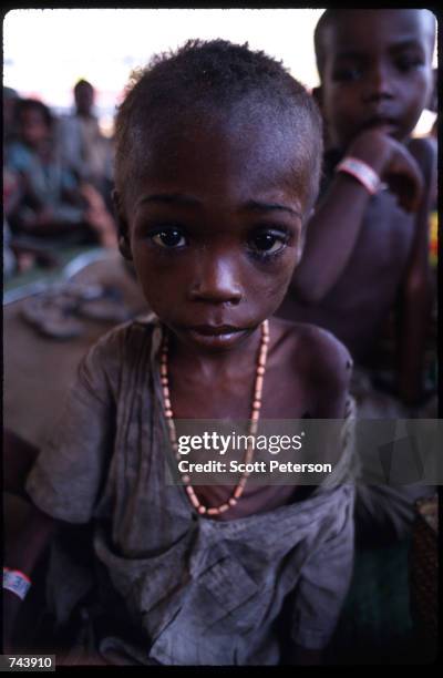 Child stands in a Somalian feeding center November 23, 1992 in Kismayo, Somalia. The country is in a state of intense civil war that is disrupting...