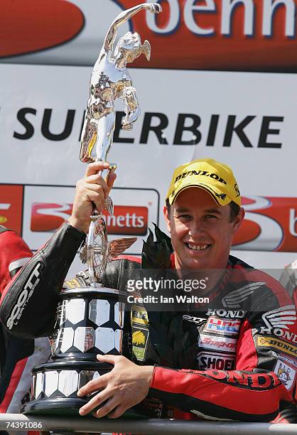 John McGuinness celebrates winning the Bennetts Superbike race at the Isle of Man TT Races on Jun 4, 2007 in Isle of Man.