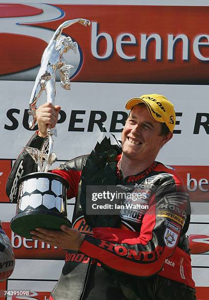 John McGuinness celebrates winning the Bennetts Superbike race at the Isle of Man TT Races on Jun 4, 2007 in Isle of Man.