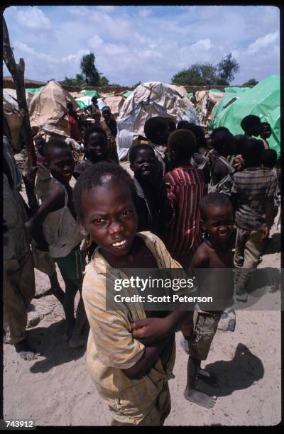 Refugees stand in line at a Somalian feeding center November 23, 1992 in Kismayo, Somalia. The country is in a state of intense civil war that is...