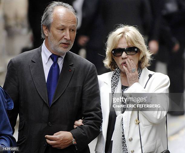 French actress Jeanne Moreau and French Pathe movie company president Jerome Clement leave after attending the funeral of French actor and filmmaker...