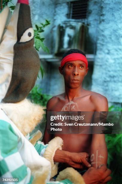 An "Ireme" or "Diablito" paints a new "Indeceme" with secret symbols before an Abacua initiation ceremony for new members on July 16, 2000 in the...