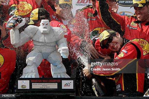 Martin Truex Jr., driver of the Bass Pro Shops/Tracker Chevrolet, celebrates with his crew after winning the NASCAR Nextel Cup Series Autism Speaks...