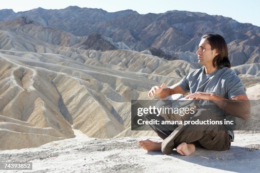 Man playing drums in desert, Death Valley, California, USA Man playing drums in desert, Death Valley, California, USA