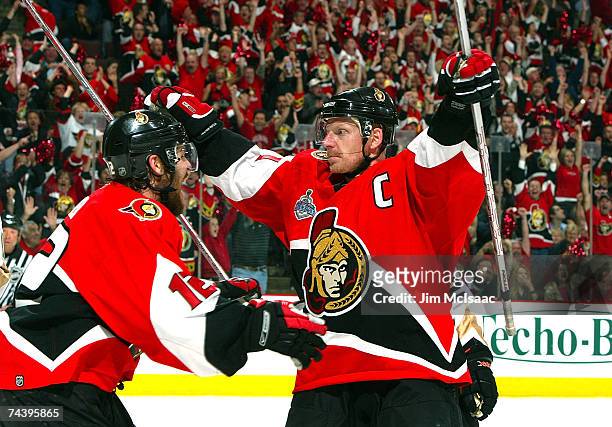Daniel Alfredsson of the Ottawa Senators celebrates his goal with teammate Mike Fisher in the final minutes of the first period of Game Four of the...