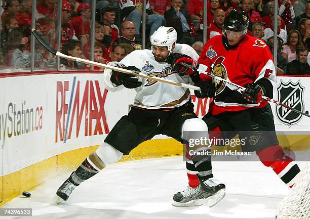 Joe DiPenta of the Anaheim Ducks battles for the puck with Christoph Schubert of the Ottawa Senators during Game Four of the 2007 Stanley Cup finals...