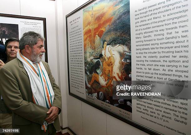 Brazilian President Luiz Inacio Lula da Silva looks at artwork of Mahatma Gandhi during a visit to the Mahatma Gandhi memorial, "Tees January Marg,...