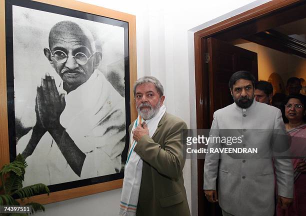 Brazilian President Luiz Inacio Lula da Silva looks at artwork of Mahatma Gandhi as Indian Minister of State for External Affairs, Anand Sharma...