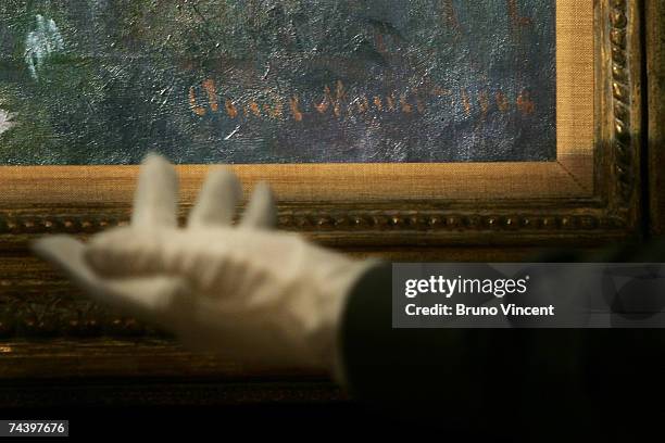 The signature on Claude Monet?s Nymph?as 1904 is displayed at Sotheby's Auction House on June 5, 2007 in London, England. The painting is on public...
