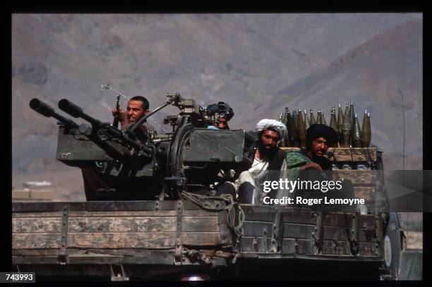 Taliban militiamen ride in a heavily armed vehicle October 10, 1996 in Kabul, Afghanistan. The Taliban army faces opposition by the guerrillas of...