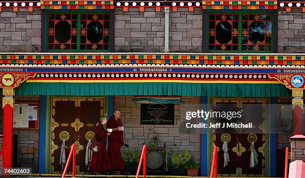 Monks at the Samye Ling Buddhist Monastery and Tibetan Centre, walk past the temple June 5, 2007 in Eskdalemuir in Scotland. The centre largest of...