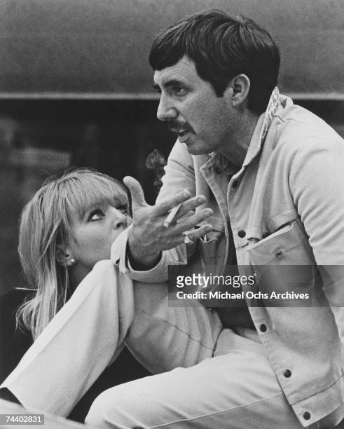 Songwriter and record producer Lee Hazlewood recording in the studio circa 1966. Singer Nancy Sinatra may be the woman in the picture. The back of...