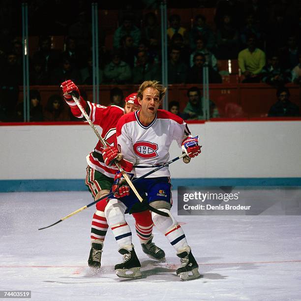 S: Guy Lafleur of the Montreal Canadiens fights for position against the New Jersey Devils during an NHL game in Montreal, Canada.