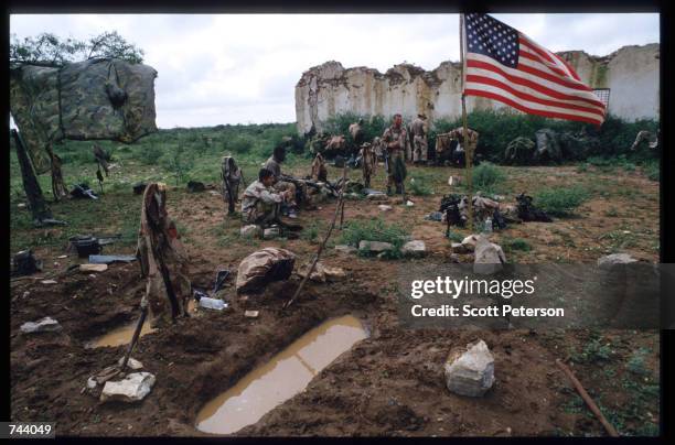 Marines sit while on a peacekeeping mission December 17, 1992 in Baidoa, Somalia. From August to November 1992, an estimated 21,000 of Baidoa's...