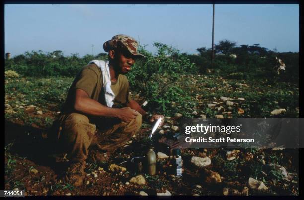 Marine brushes his teeth while on a peacekeeping mission December 17, 1992 in Baidoa, Somalia. From August to November 1992, an estimated 21,000 of...