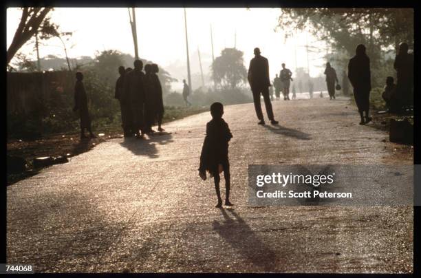 Baidoans walk in a road December 17, 1992 in Baidoa, Somalia. From August to November 1992, an estimated 21,000 of Baidoa's 37,000 population died in...