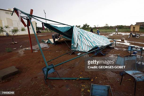 Man repais a tent after it was destroyed by a strong storm near the "Babemba Traore" stadium in Sikasso, Mali, during a forum to counter the G8...