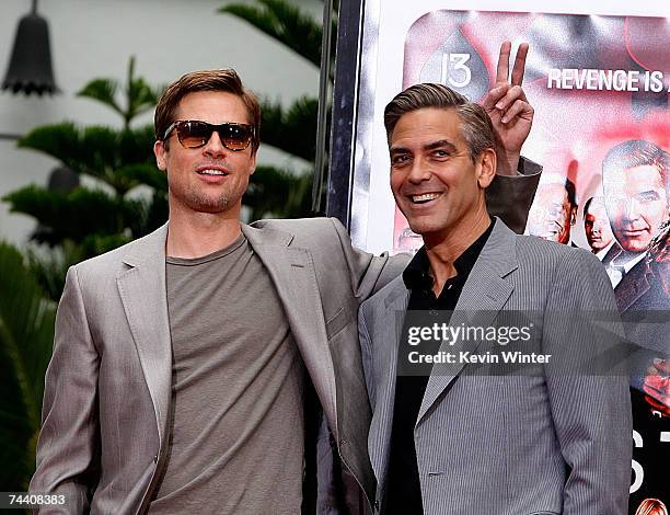 Actors Brad Pitt and George Clooney , stars of the film Ocean's 13, pose for photos during their hand and footprints ceremony at Grauman's Chinese...