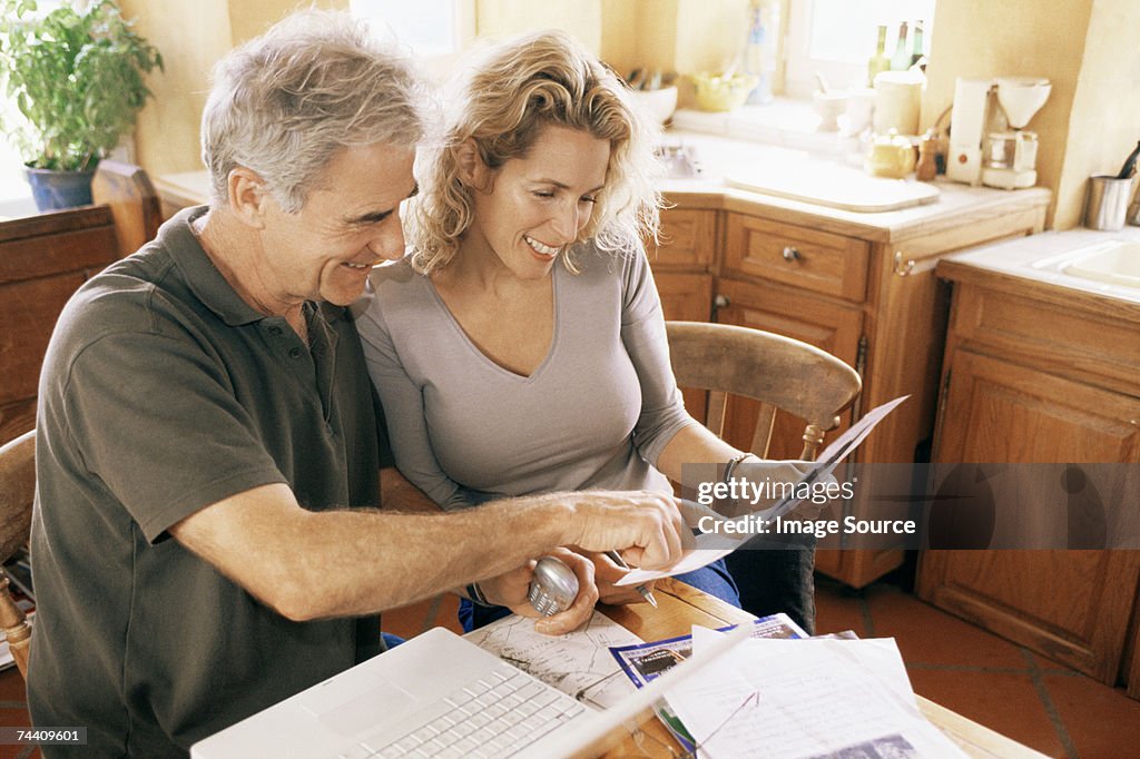 Couple with laptop and paperwork