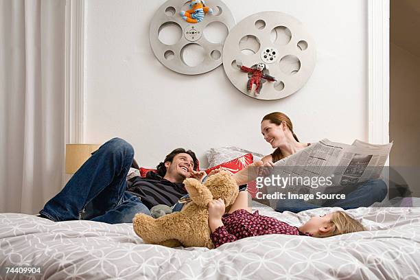 family relaxing on bed - letto matrimoniale foto e immagini stock