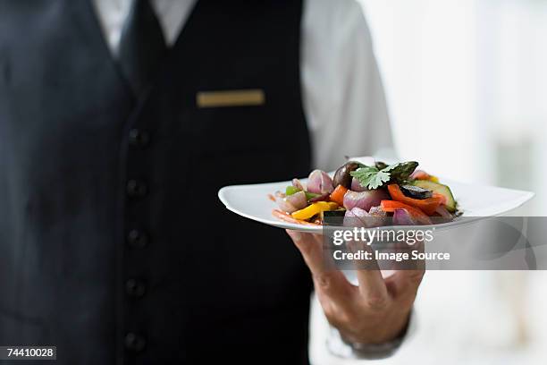 waiter holding plate - kelner stockfoto's en -beelden