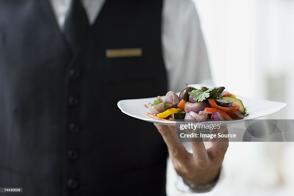 Waiter holding plate