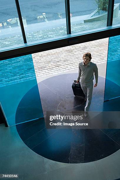 man walking into hotel - automatic stock pictures, royalty-free photos & images