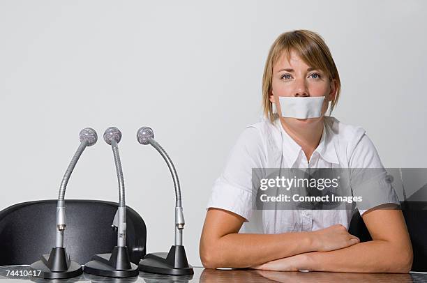 businesswoman's mouth covered with a plaster - gagged woman stock pictures, royalty-free photos & images