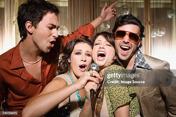 friends doing karaoke - singing group stock pictures, royalty-free photos & images