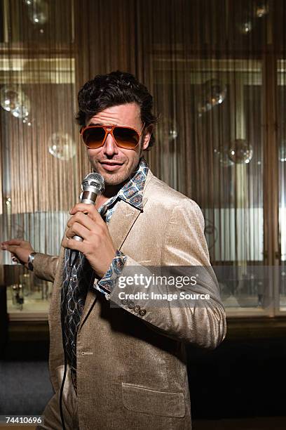 retro man doing karaoke - night suit stock pictures, royalty-free photos & images