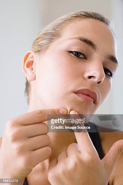 woman squeezing spot - adult acne stock pictures, royalty-free photos & images