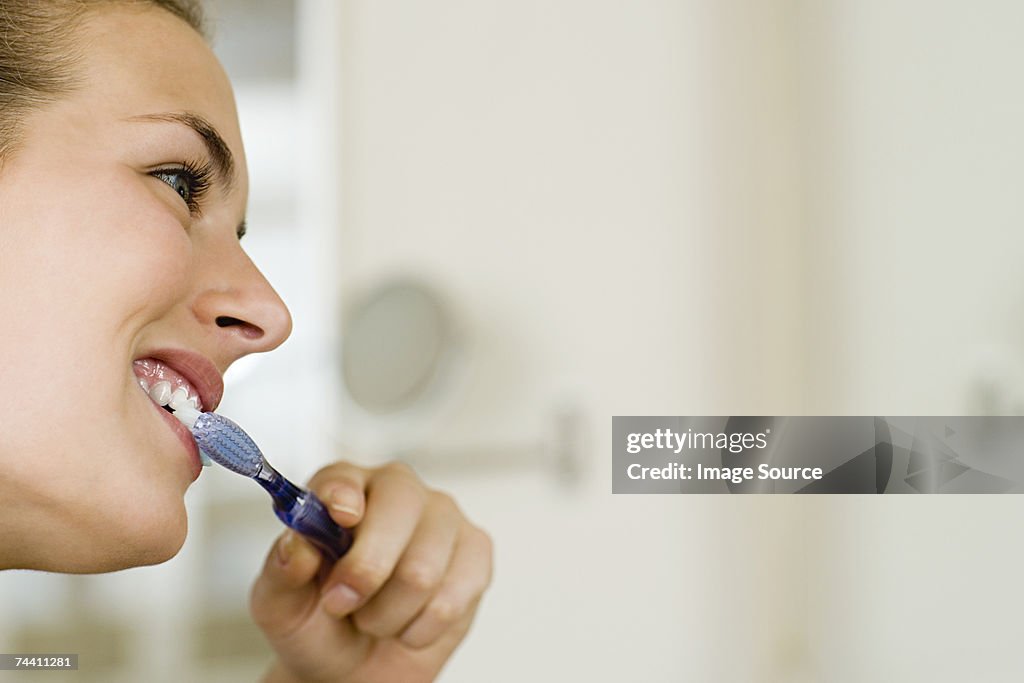 Woman brushing teeth