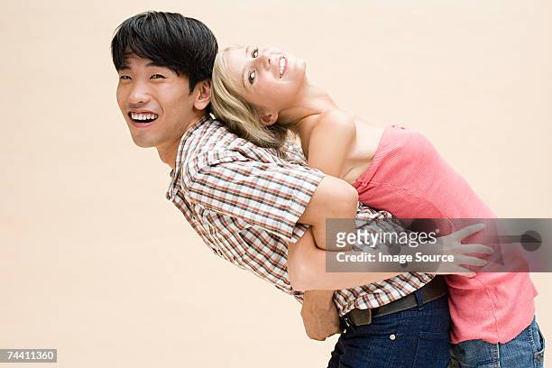 young couple back to back - tcs stock pictures, royalty-free photos & images