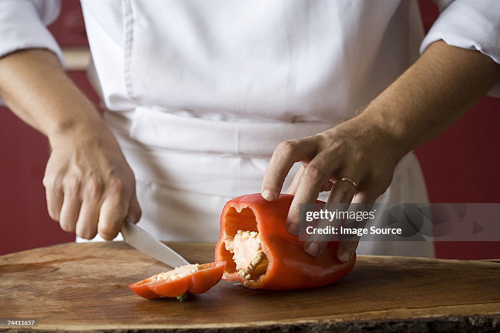 Chef cutting pepper