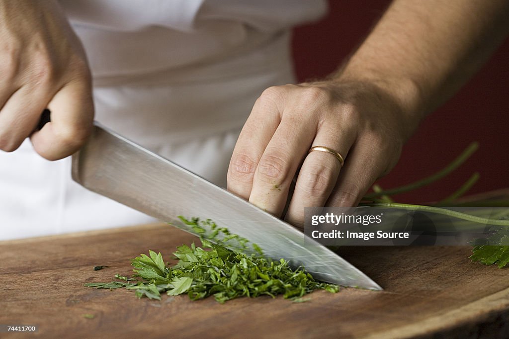 Chef chopping parsley