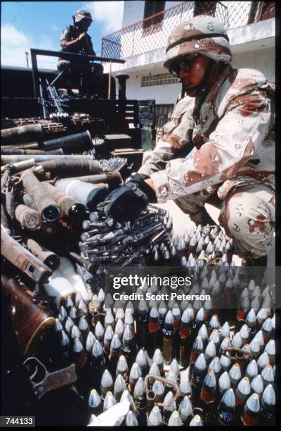 An unidentified U.S. Soldier looks over an arsenal of confiscated ammunition January 11, 1993 in Mogadishu, Somalia. The United Nations hopes to...