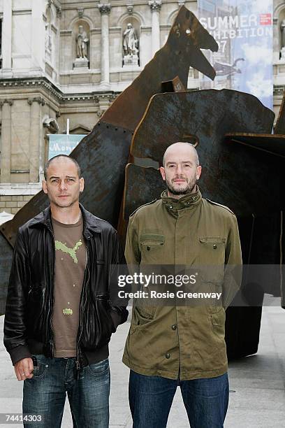 Dinos and Jake Chapman pose beside their artwork 'The Meek Shall Inherit The Earth, But Not The Mineral Rights' at The Royal Academy of Arts 239th...