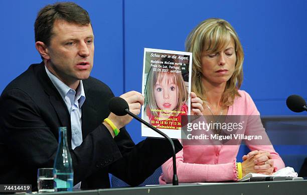 Kate and Gerry McCann, the parents of the missing 4-year-old British girl Madeleine McCann, hold up a picture of Madeleine during a press conference...
