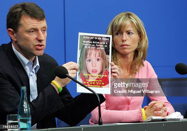 Kate and Gerry McCann, the parents of the missing 4-year-old British girl Madeleine McCann, display a poster of their missing daughter during a press...
