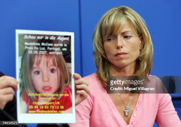 Kate Mc Cann, the mother of the missing 4-year-old British girl Madeleine McCann looks at a poster showing her missing daughter during a press...