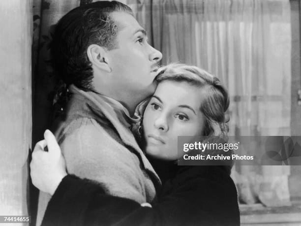 English actor Laurence Olivier as Max de Winter and Joan Fontaine as the second Mrs de Winter in the dark romance 'Rebecca', directed by Alfred...