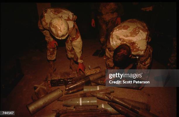 Marines inspect confiscated shells January 11, 1993 Mogadishu, Somalia. The United Nations hopes to restore order and save hundreds of thousands with...