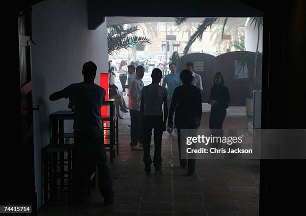 Clubbers walk out into the daylight at seven thirty after a night out at Pacha nightclub in Eivissa town on June 5, 2007 in Ibiza, Spain. Pacha will...