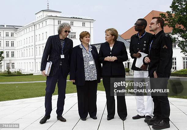 German Chancellor Angela Merkel poses for a picture with Irish pop band U2 frontman Bono , Irish political activist Bob Geldof , the chairwoman of...