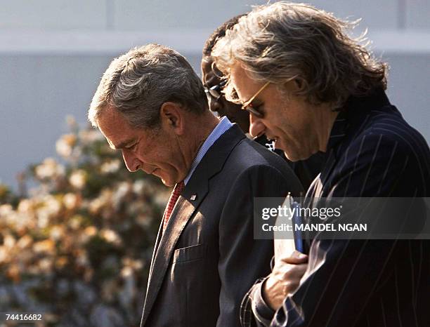 President George W. Bush walks Irish political activist Bob Geldof and Senegalese musician Youssou N'Dour 06 June 2007 before a meeting on the Baltic...