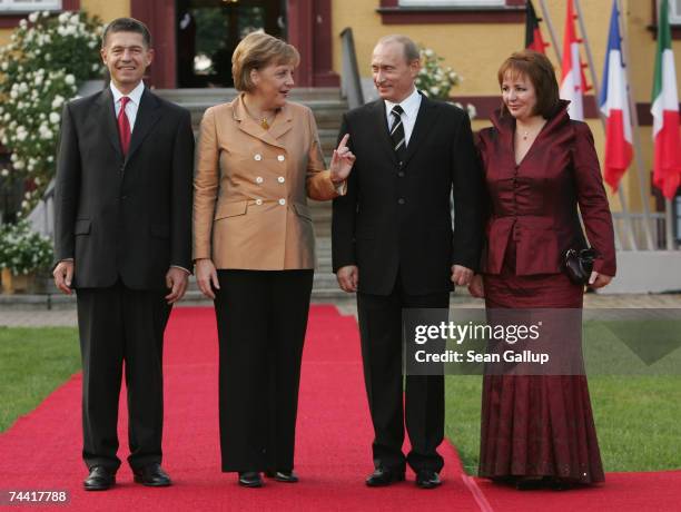 German Chancellor Angela Merkel and her husband Joachim Sauer welcome Russian President Vladimir Putin and his wife Lyudmila Putina at the opening...