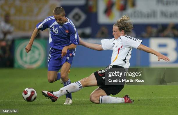 Marcell Jansen of Germany tries to stop Stanislav Sestak of Slovakia during the UEFA EURO 2008 qualifier between Germany and Slovakia at the AOL...